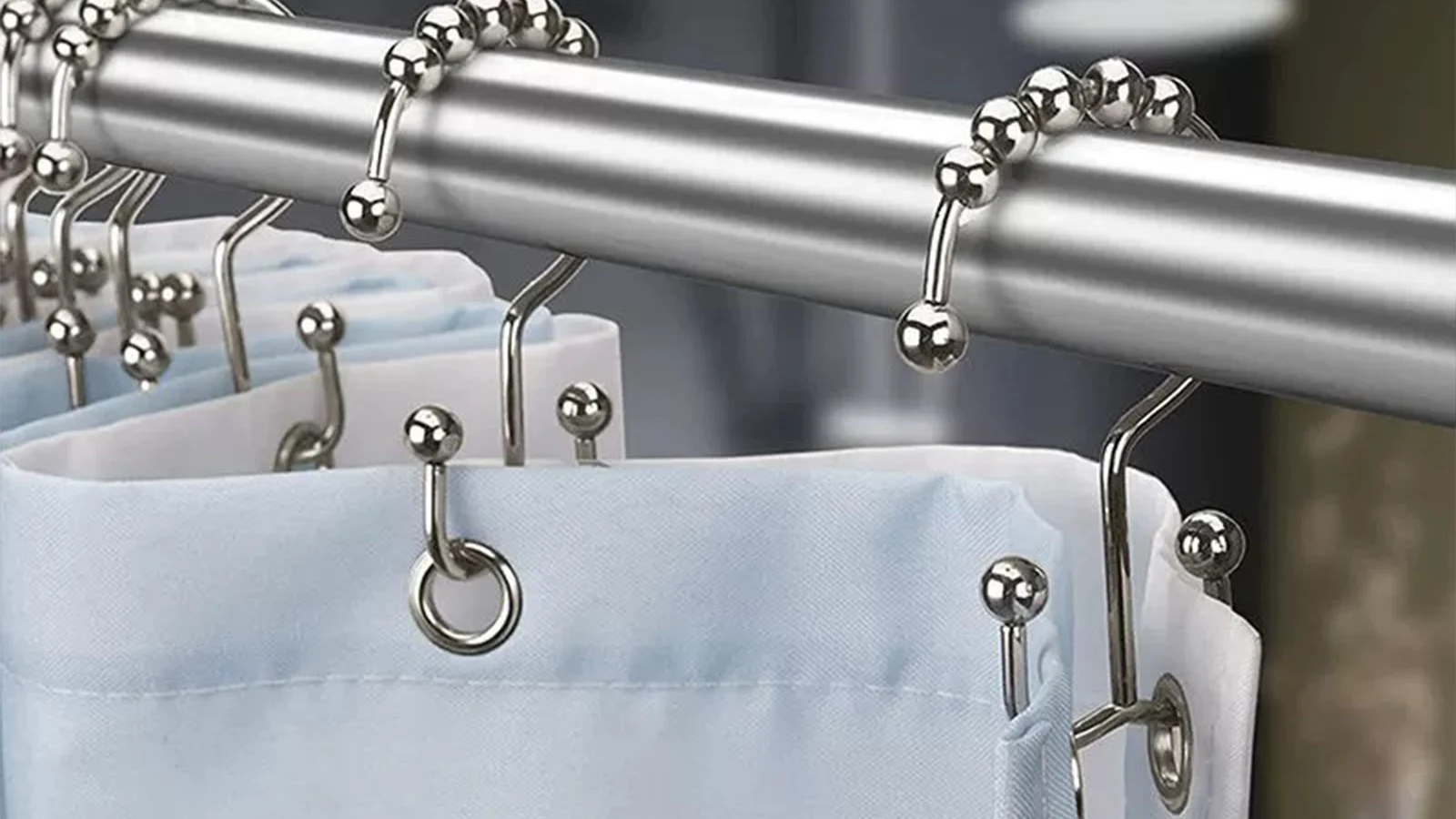 Types of Shower Curtain Hooks: A set of clothes hanging on a metal rod.