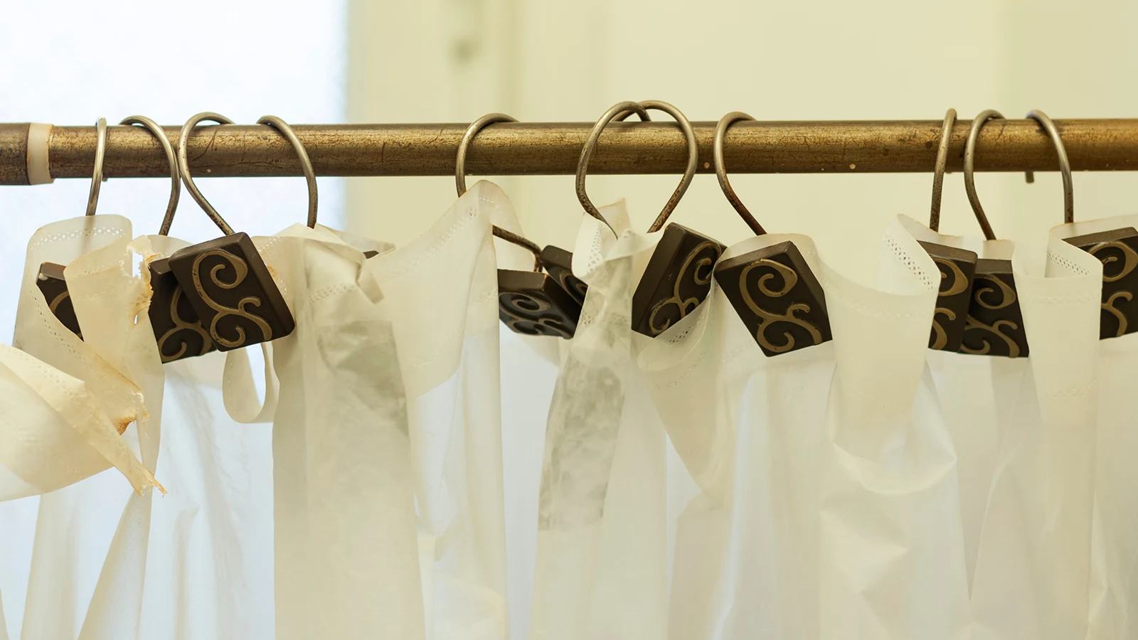 Types of Shower Curtain Hooks: White plastic bags hanging from a shower rod.