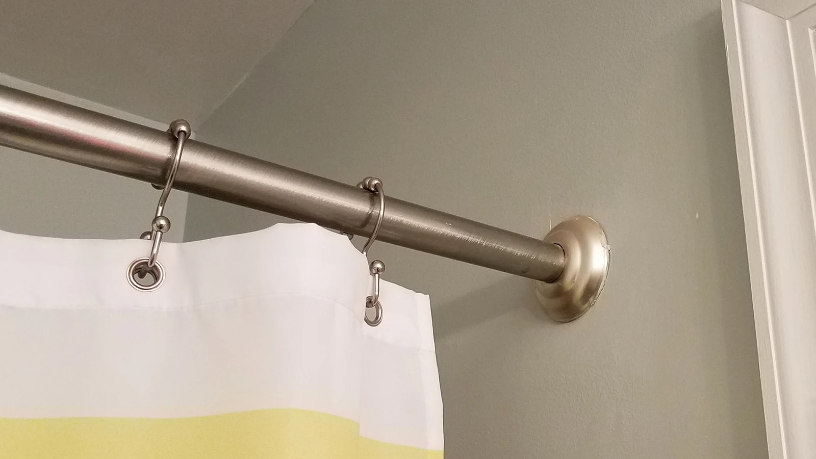 Types of Shower Curtain Hooks: A shower curtain hanging on a metal rod.